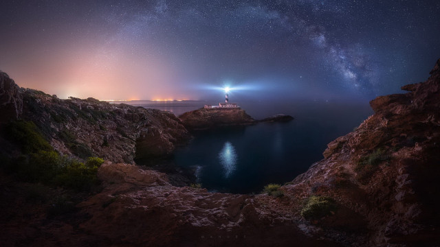 Lighthouse rocky cliff night sky free wallpaper for desktop - medium preview image