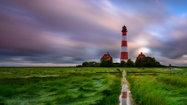 Lighthouse grassy island path person free wallpaper for desktop - medium preview image