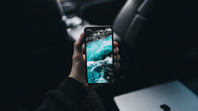 Person holding cellphone car laptop free wallpaper for desktop - medium preview image