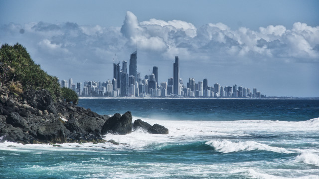 City skyline ocean waves rocky free wallpaper for desktop - medium preview image