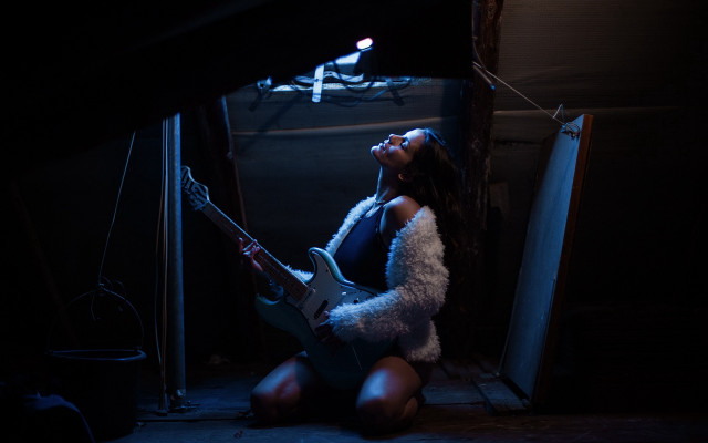 Woman playing guitar dark room free wallpaper for desktop - medium preview image