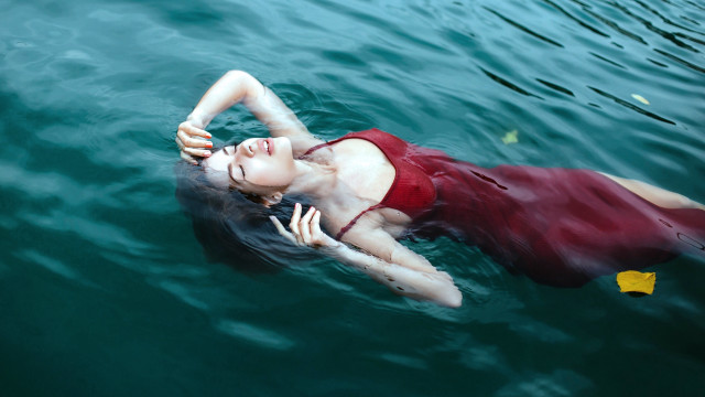 Woman floating water yellow object free wallpaper for desktop - medium preview image