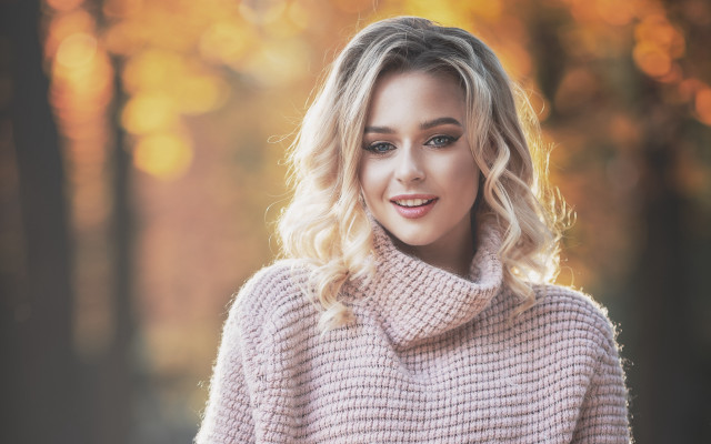 Blonde woman pink sweater smiling free wallpaper for desktop - medium preview image