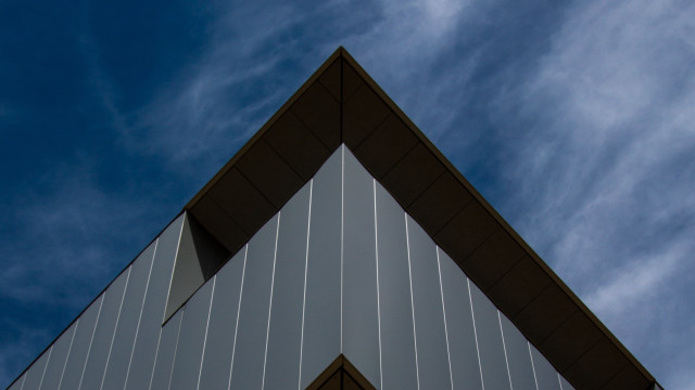 Building triangular roof blue sky free wallpaper for desktop - medium preview image