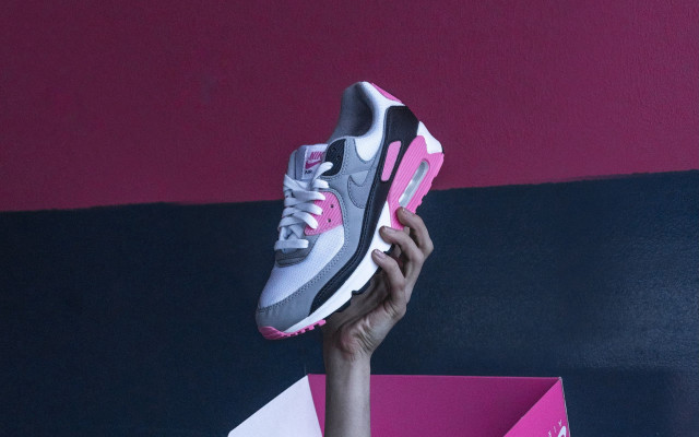 Person holding pink grey shoe free wallpaper for desktop - medium preview image