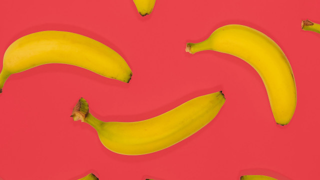 Bananas pink surface red background free wallpaper for desktop - medium preview image