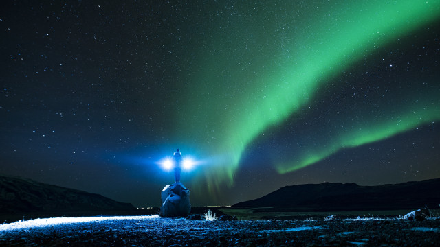 Person aurora night sky flashlight free wallpaper for desktop - medium preview image