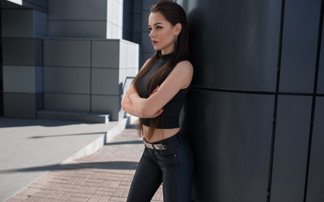 Woman leaning wall crossed arms free wallpaper for desktop - medium preview image