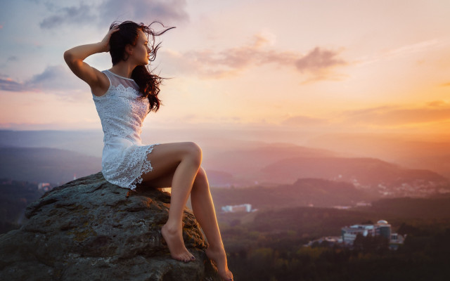Woman sitting rock wind sunset free wallpaper for desktop - medium preview image