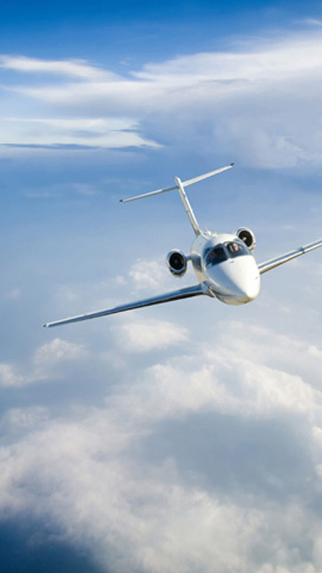 Jetliner flying blue cloudy sky free wallpaper for mobile - medium preview image