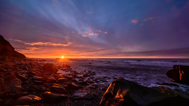 Sunset rocky beach water shore free wallpaper for desktop - medium preview image