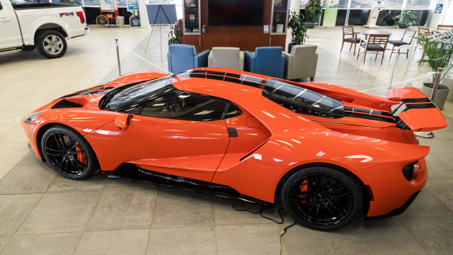 Bright orange sports car showroom #4 free wallpaper for desktop - medium preview image