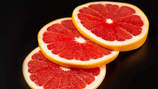 Grapefruit slices black background food free wallpaper for desktop - medium preview image
