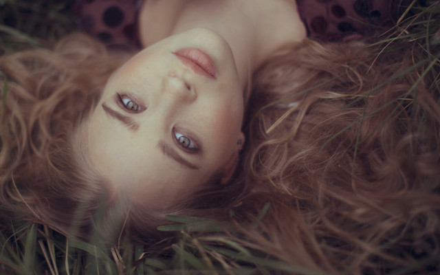Woman lying grass blowing hair free wallpaper for desktop - medium preview image