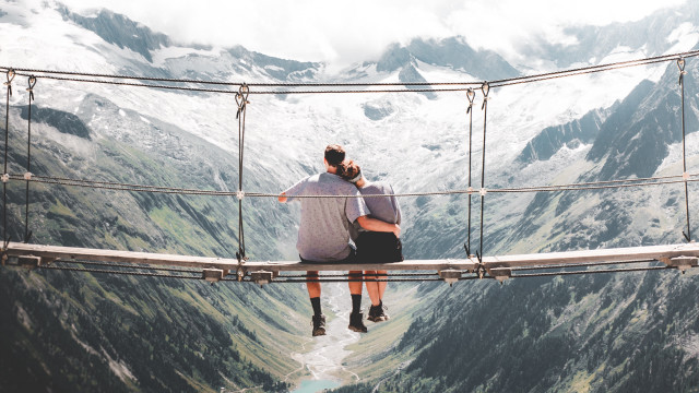 Suspension bridge man mountains hands free wallpaper for desktop - medium preview image