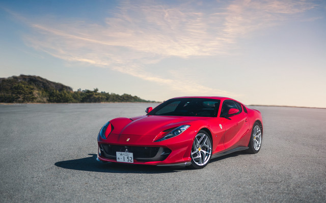 Red sports car road hill free wallpaper for desktop - medium preview image