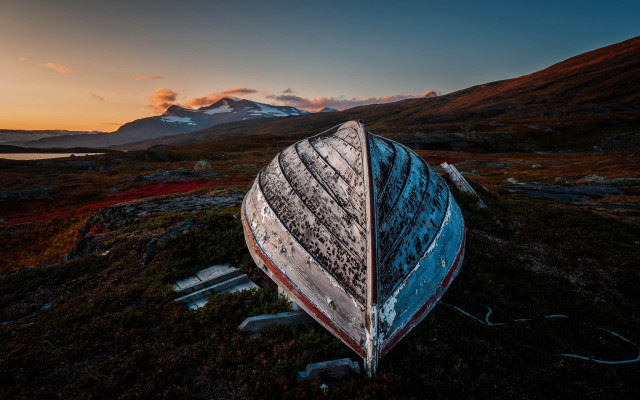 Boat grass mountain sunset sky free wallpaper for desktop - medium preview image