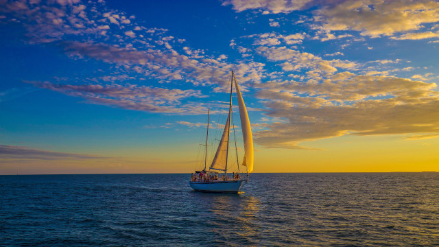Sailboat ocean sunset clouds people free wallpaper for desktop - medium preview image