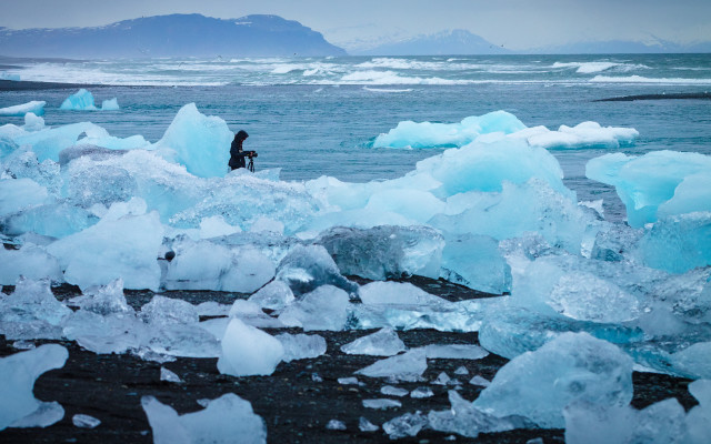 Man beach ice chunks mountains free wallpaper for desktop - medium preview image