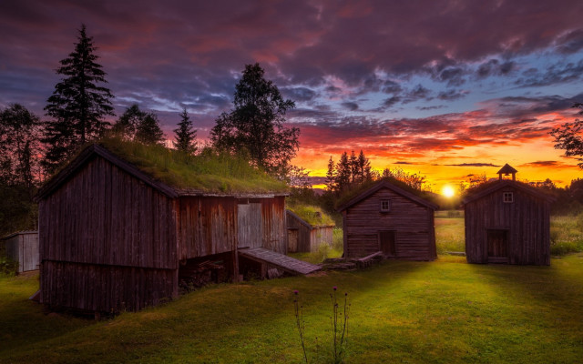 Sunset grassy field wooden buildings free wallpaper for desktop - medium preview image