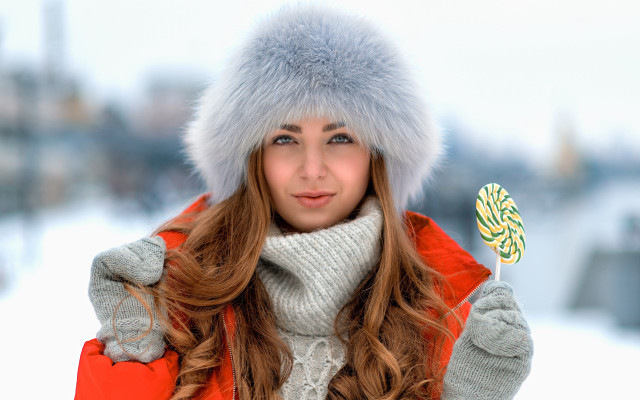 Winter coat woman holding candy free wallpaper for desktop - medium preview image