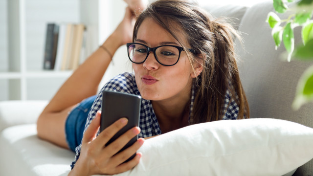 Surprised woman couch phone plaid free wallpaper for desktop - medium preview image