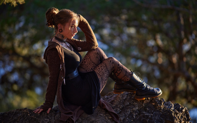 Woman sitting rock brown sweater free wallpaper for desktop - medium preview image