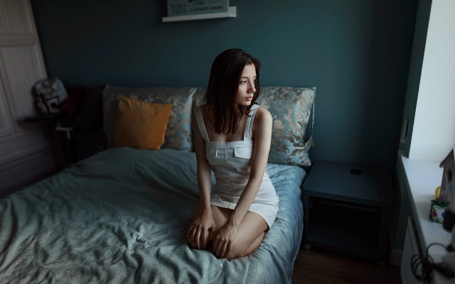 Woman sitting bed blue wall free wallpaper for desktop - medium preview image