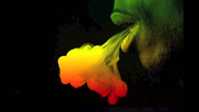 Man blowing colorful smoke fire free wallpaper for desktop - medium preview image