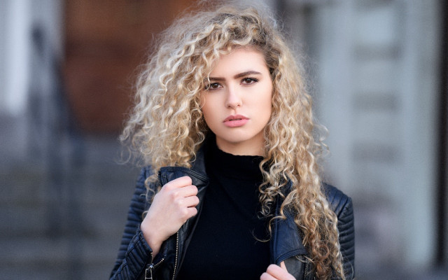 Woman curly hair jacket portrait free wallpaper for desktop - medium preview image
