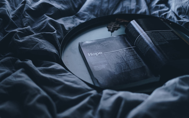 Black book on bed cinematic free wallpaper for desktop - medium preview image