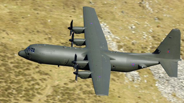 Military plane flying over grass free wallpaper for desktop - medium preview image