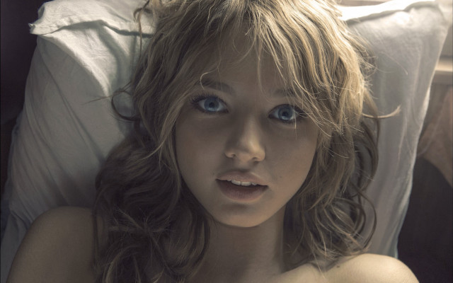 Blue eyed woman laying in free wallpaper for desktop - medium preview image