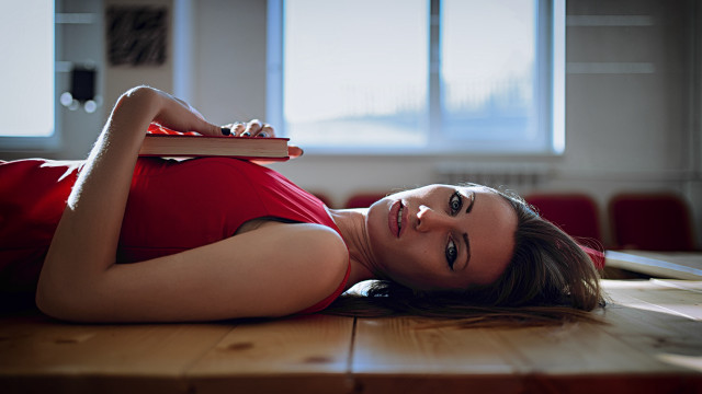 Woman laying on floor with free wallpaper for desktop - medium preview image