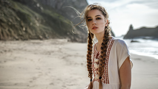 Woman braids beach ocean cliff free wallpaper for desktop - medium preview image
