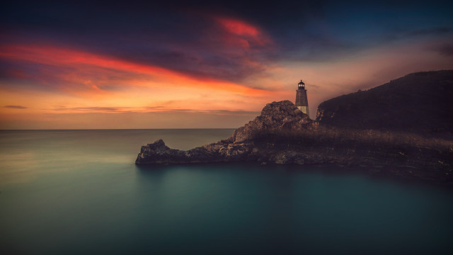 Lighthouse rocky outcrop ocean sunset free wallpaper for desktop - medium preview image