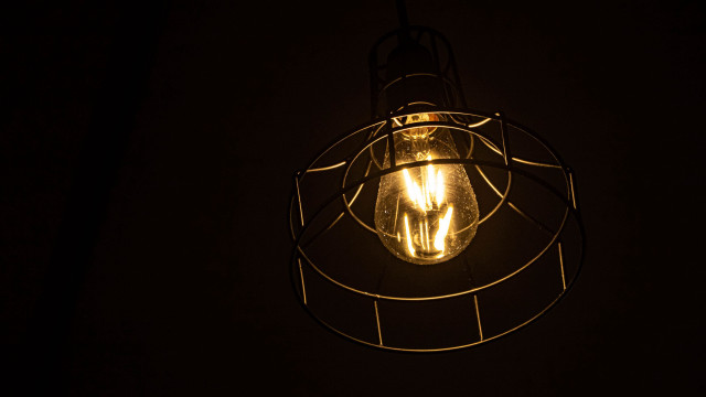 Lit bulb wire cage dark free wallpaper for desktop - medium preview image