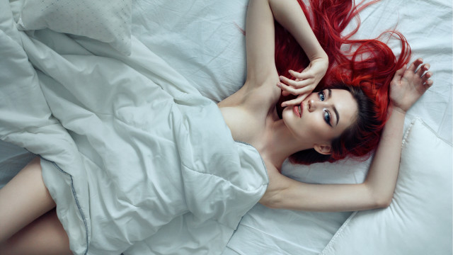 Red haired woman on bed free wallpaper for desktop - medium preview image