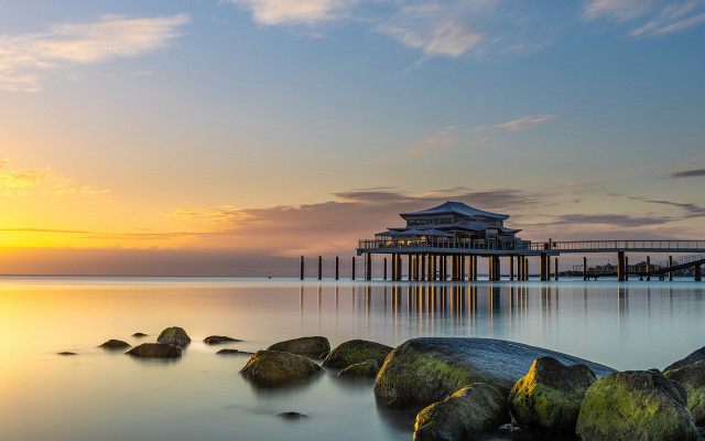 Pier building sunset rocks water free wallpaper for desktop - medium preview image