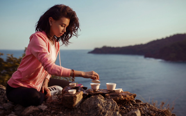 Woman sitting rock tea ocean free wallpaper for desktop - medium preview image