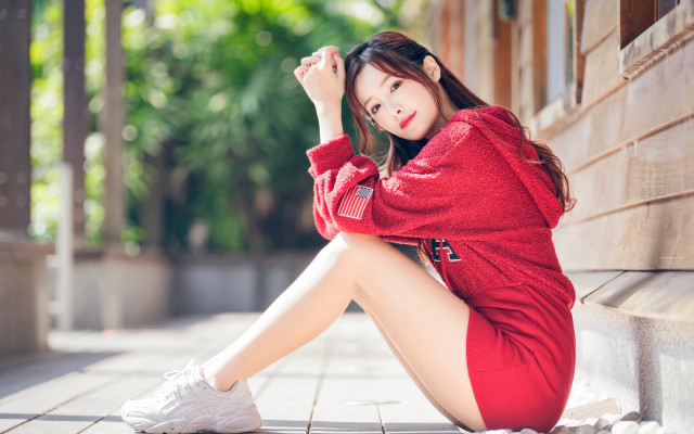 Woman red sweater sitting blurry free wallpaper for desktop - medium preview image