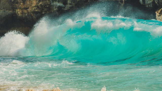 Wave shore cliff beach person free wallpaper for desktop - medium preview image