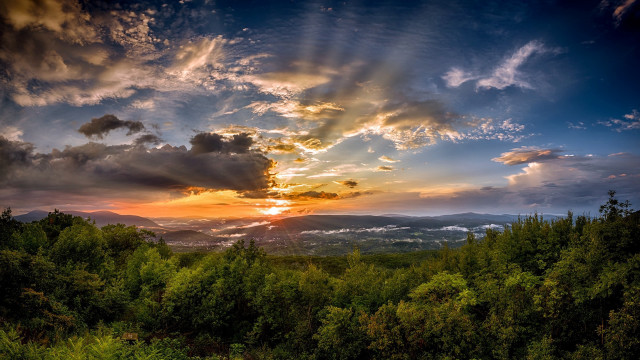 Sunset forest clouds raysovermountains cityscape free wallpaper for desktop - medium preview image