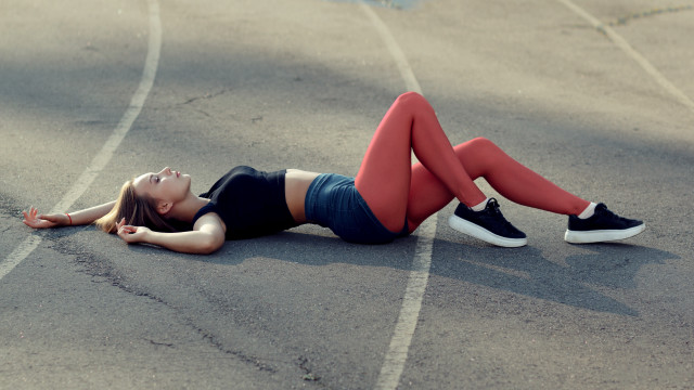 Woman laying parking lot athletic free wallpaper for desktop - medium preview image