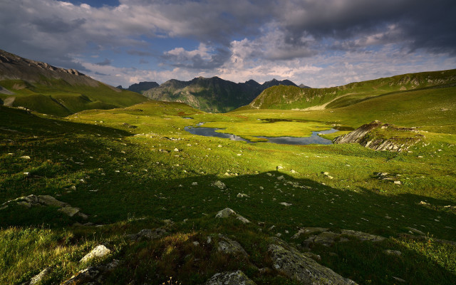 Grassy lake mountains clouds cityscape free wallpaper for desktop - medium preview image