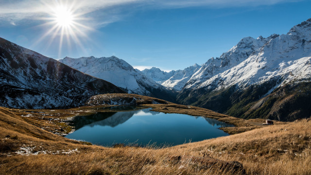 Mountain lake sunburst grassy field free wallpaper for desktop - medium preview image