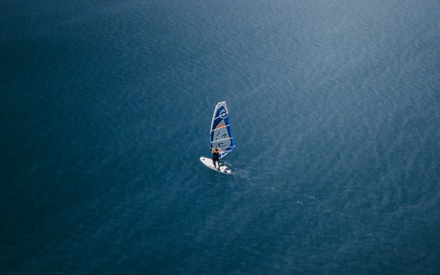 Sailboat rider ocean sunny day free wallpaper for desktop - medium preview image
