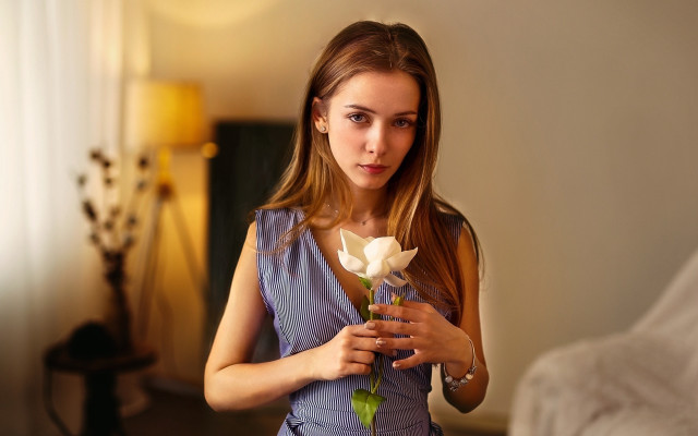 Woman holding flower serious portrait free wallpaper for desktop - medium preview image