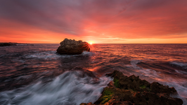Mystical rock island sunset ocean free wallpaper for desktop - medium preview image