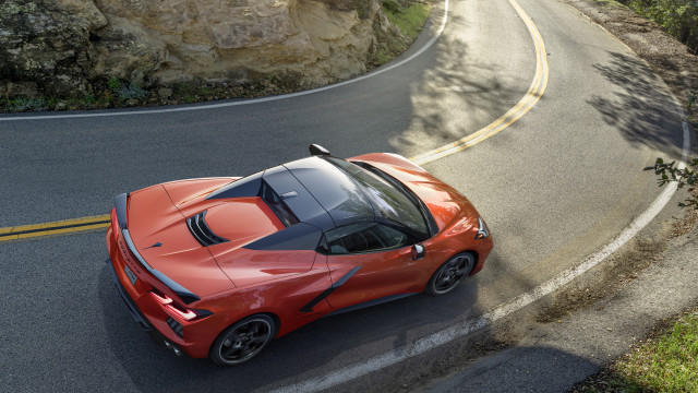 Red sports car winding road free wallpaper for desktop - medium preview image